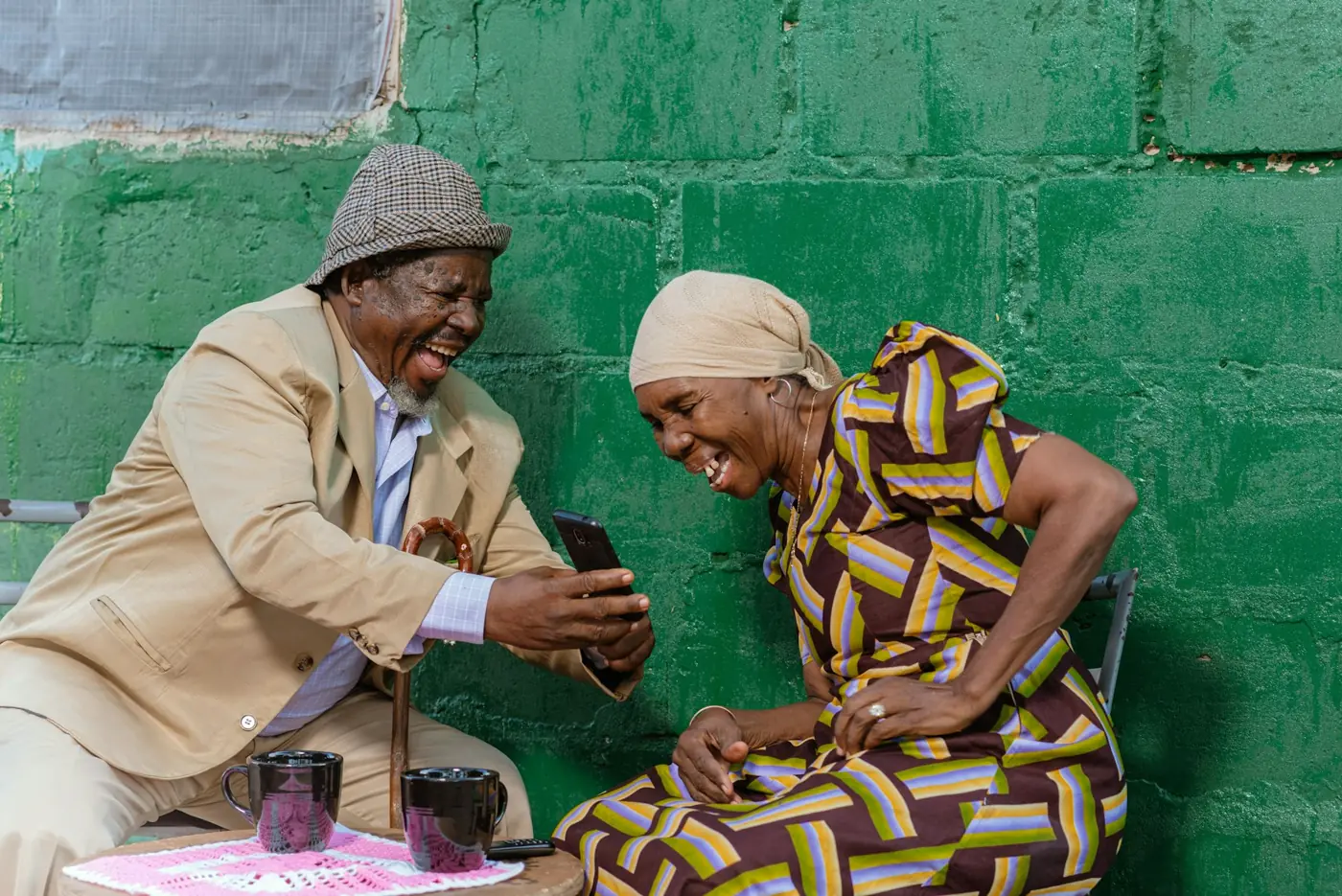 An older couple speaking together on a phone